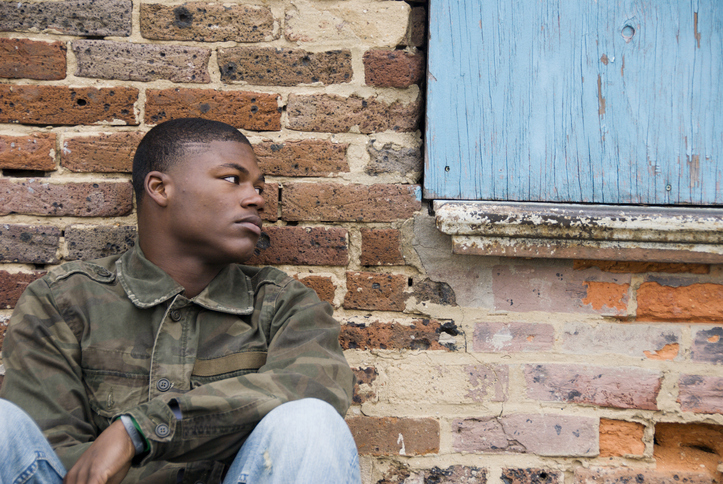 Serious black man sitting and looking to the right side