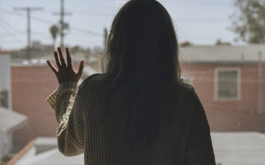 shape of a lady putting hand on a window