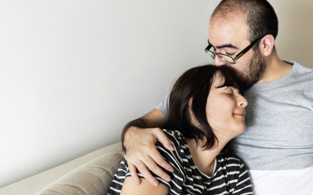 Man hugging woman to show support