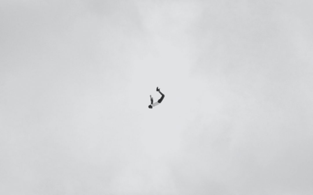 artistic image that shows a falling man in the middle and a dark cloud at the top and bottom