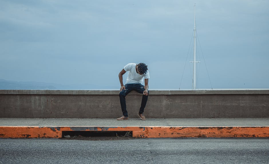 a man sitting on the road