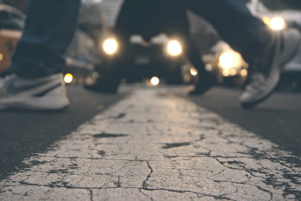 close up of people's foots while crossing the street