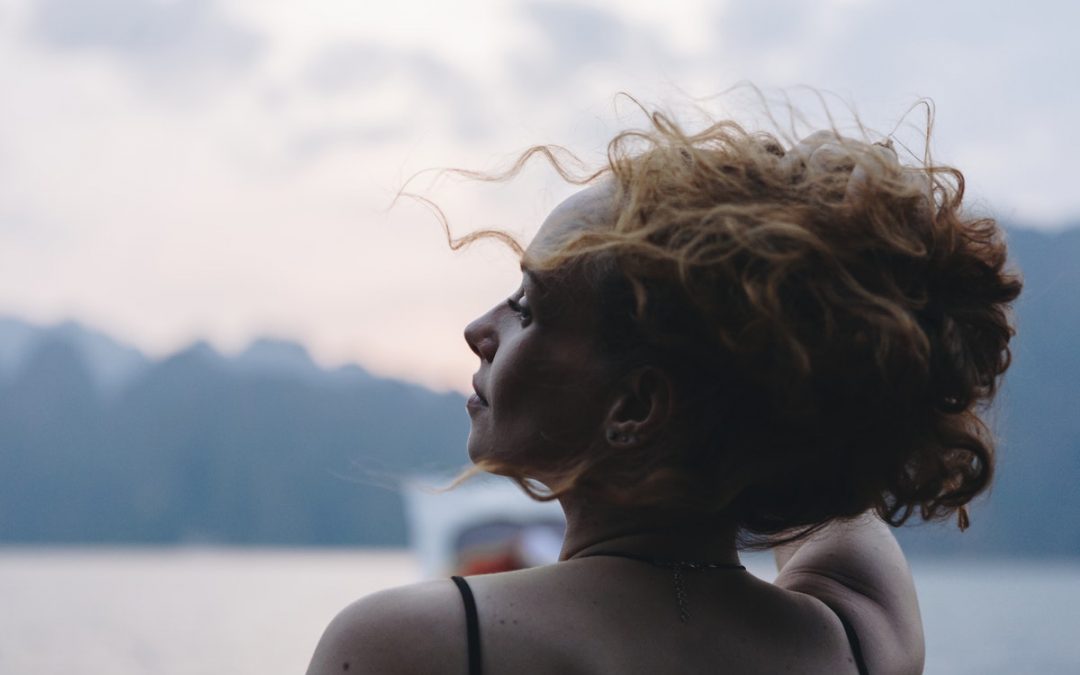 woman sitting by the lake