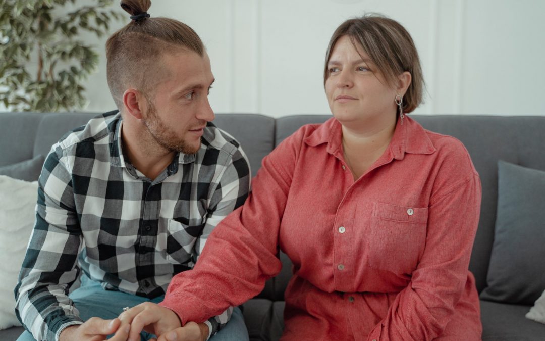 a couple sitting in a couch